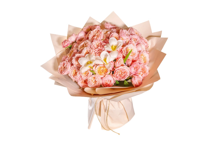 A bouquet of pink and white flowers, wrapped in brown paper with a ribbon.