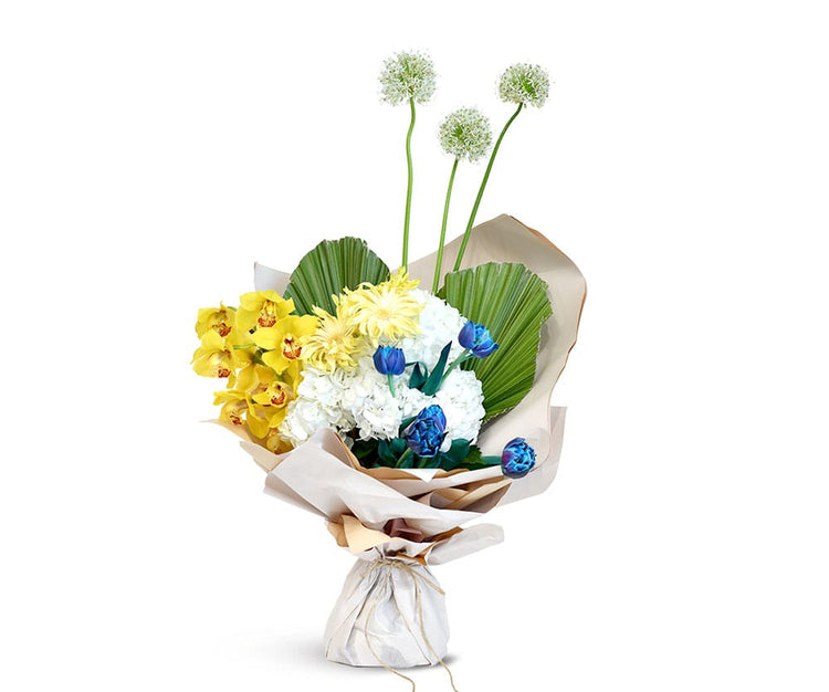 Bouquet of flowers with yellow, white, and blue flowers wrapped in brown paper on a white background.